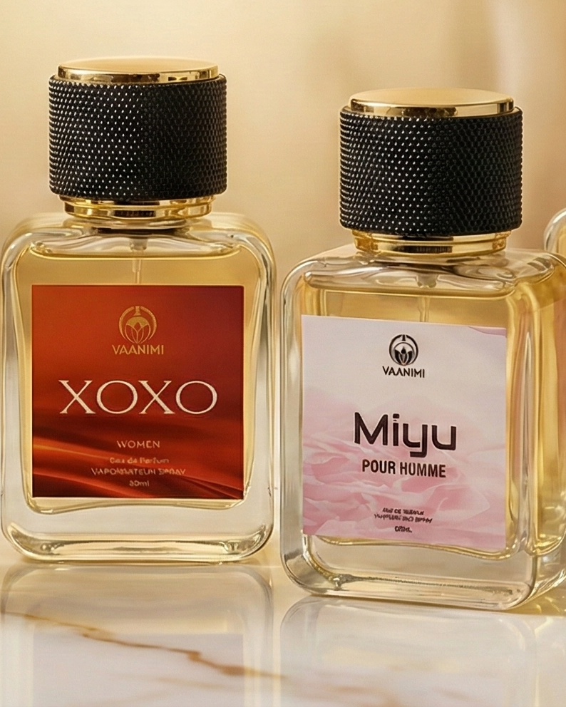 Five perfume bottles with visible brand names on a marble surface.